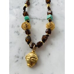 Long leather necklace with gold pleated African pendant