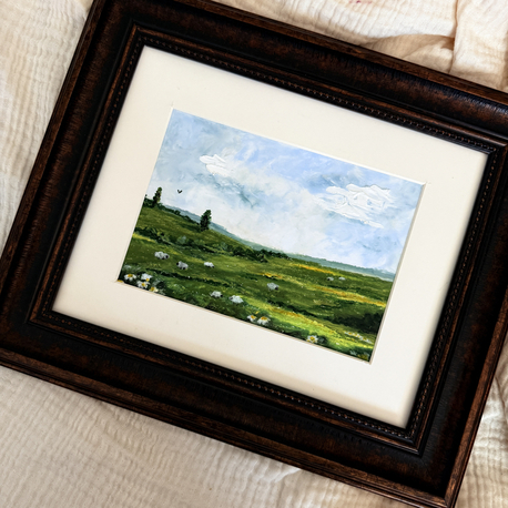 The tones of the green meets with some sheep in the meadow