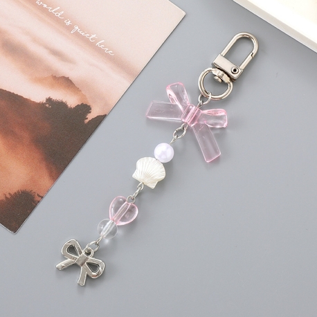 Coquette pembe fiyonk detaylı çanta ve telefon charmı