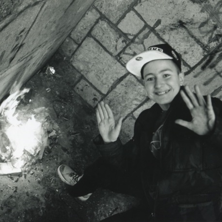 A Young Boy Around Fire