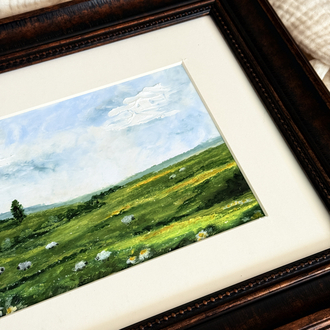 The tones of the green meets with some sheep in the meadow