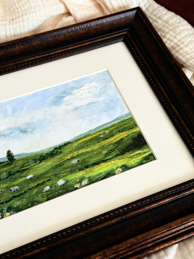 The tones of the green meets with some sheep in the meadow