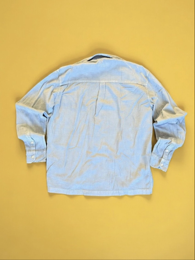 Mavi Marka Hafif dokulu açık mavi chambray gömlek. Rahat oversize kesim, zamansız parça.