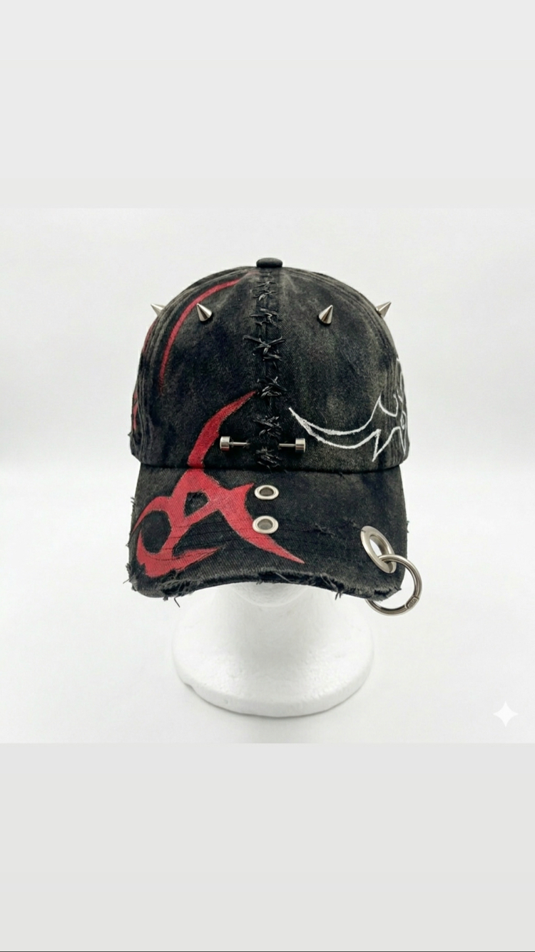 Red & black tribal cap with chain detail.